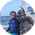 An image of two happy shark divers on board a west florida shark diving tour. 